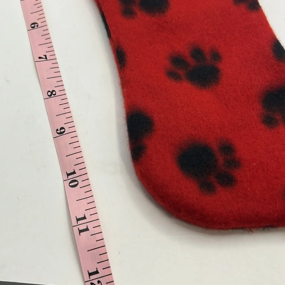 Red Christmas Stocking with Black Paw Prints.